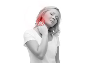 unhappy woman suffering from pinched nerve and neck pain