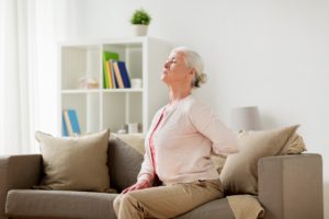 senior woman suffering from pain in back at home