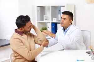 doctor and patient with arm pain