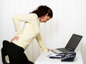 Image of woman with back pain from a bulging disc